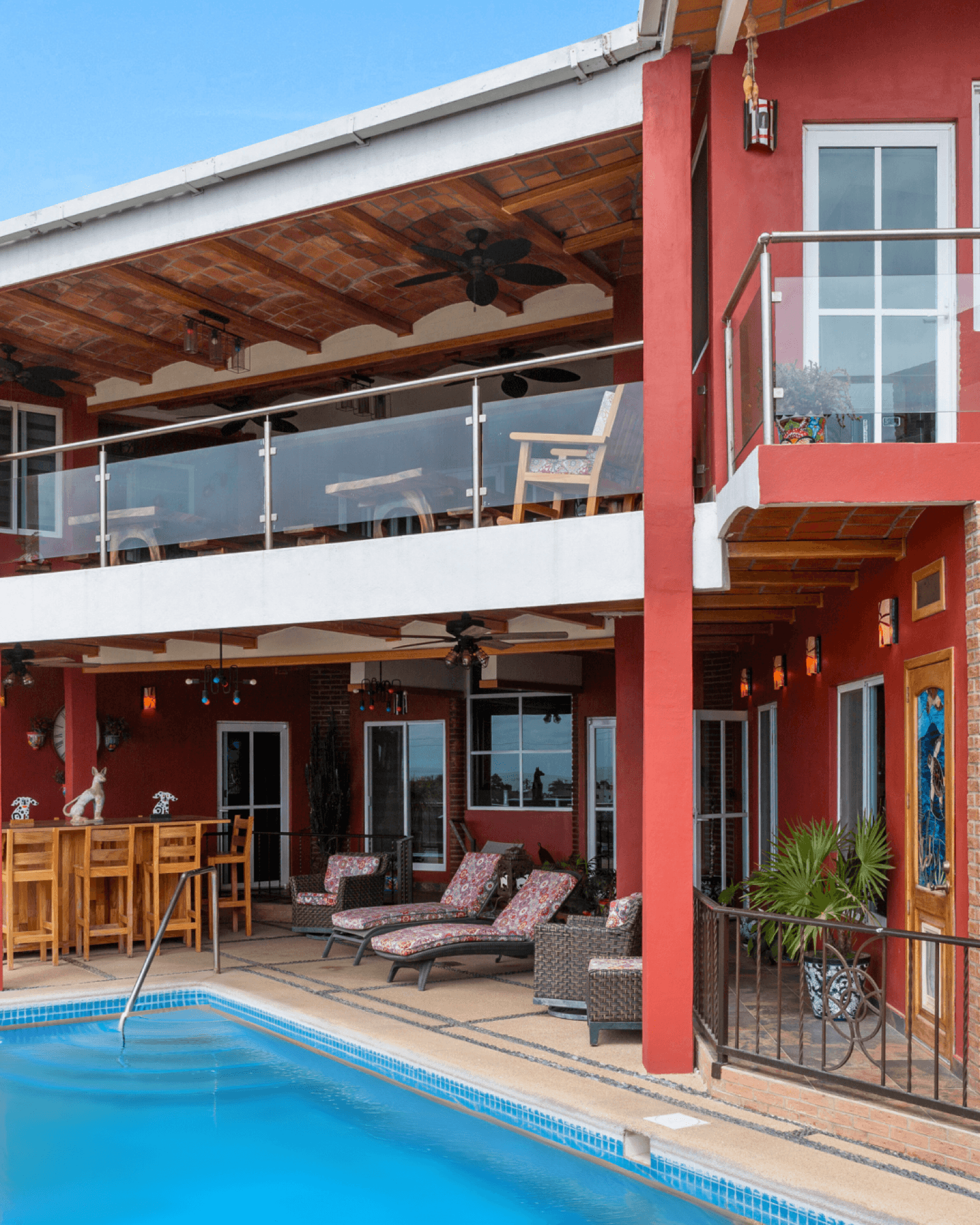 Multi-level pool terrace with outdoor bar and loungers